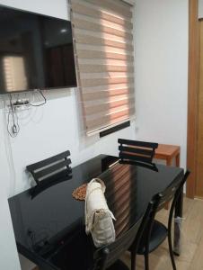 a dining room with a table and two chairs at Un Studio haut standing à Monastir in Monastir +4 photos