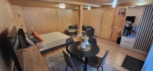 a room with a bed and a table and chairs at Sodyba pas Babą - Apartamentai SMILGIJA Šventoji in Palanga