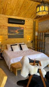 a bedroom with a large bed in a wooden room at Chalés Rancho Queimado in Rancho Queimado +58 photos