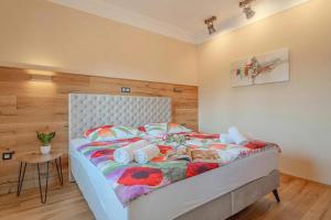 a bedroom with a large bed with a white headboard at Vila Trate with Shared Pool and Garden in Ljutomer
