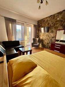 a bedroom with a yellow bed and a living room at Willa Zofia in Rabka-Zdrój +81 photos