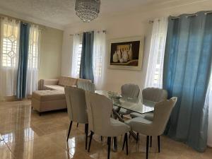 a living room with a glass table and chairs at Casa Kaibana - 6 Pax, con piscina, cerca del mar in Las Galeras