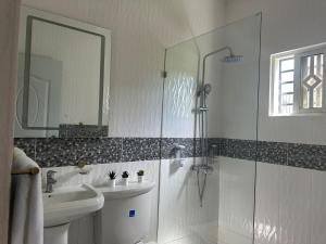 a white bathroom with a shower and a sink at Casa Kaibana - 6 Pax, con piscina, cerca del mar in Las Galeras +27 photos