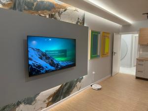 a living room with a flat screen tv on a wall at RICH 2 Apartment in Plovdiv