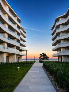a sidewalk in front of a large apartment building at PEARL COAST Luxury Rogowo Pool Beach in Rogowo