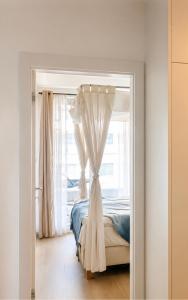 a bedroom with a bed and a window at PEARL COAST Luxury Rogowo Pool Beach in Rogowo