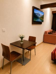 a living room with a table and chairs and a couch at Komnata Bešeňová - Apartmán 344 in Bešeňová