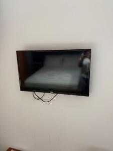 a flat screen tv hanging on a white wall at Hotel Noel in Vlorë
