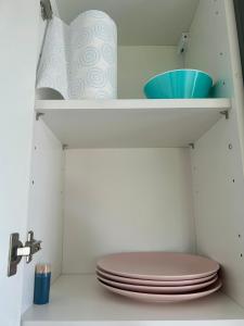 a bathroom with a toilet and a shelf with toiletries at Studio cosy 71 in Saint-Vallier