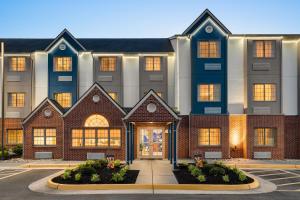 a large apartment building with a front door at Microtel Inn & Suites by Wyndham Culpeper in Culpeper