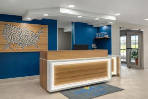 an office with blue walls and a reception desk at Microtel Inn & Suites by Wyndham Culpeper in Culpeper