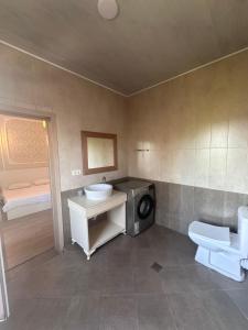 a bathroom with a sink and a washing machine at Kobuleti 327 a in Kobuleti +19 photos