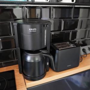 a coffee maker is sitting on a shelf at Idyllischer Bungalow am Badesee in Reuthen