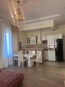 a kitchen and dining room with a table and chairs at Kobuleti 327 a in Kobuleti