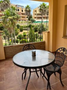 a table and chairs on a balcony with a view at A spacious apartment with an ocean view in Mijas Costa