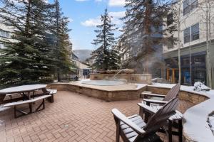a patio with a hot tub in the snow at Silver Mill #8274 in Keystone