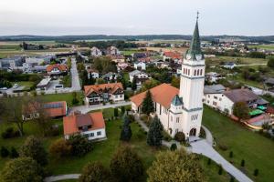 an aerial view of a small town with a church at Hostel 1550 in Moravske-Toplice +21 photos