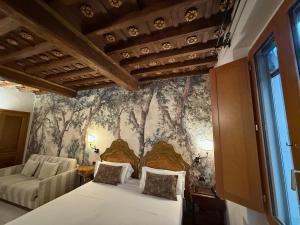 a bedroom with a bed and a wall mural at II Guelfo Bianco in Florence