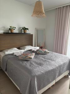 a bedroom with a large bed with two pillows on it at Lake view Helmi in Jyväskylä