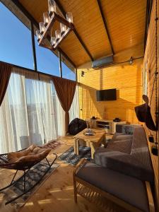 a living room with a couch and a table at West Coast Cottage Buknari in Buknari