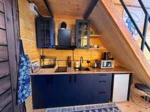 a kitchen in the middle of a house at West Coast Cottage Buknari in Buknari