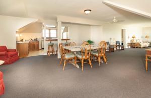 a dining room and living room with a table and chairs at Anchorage Inn & Marina in Ocracoke