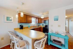 a kitchen with a table and chairs in it at North Point Condo 301 in Ocean City