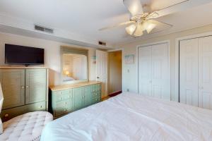 a bedroom with a white bed and a ceiling fan at North Point Condo 301 in Ocean City +4 photos