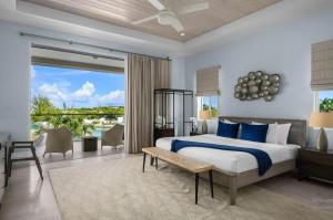 a bedroom with a bed and a large window at Second Wind Villa in Long Bay Hills +19 photos