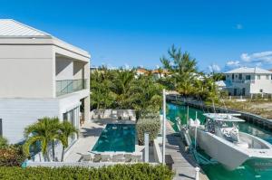 a boat is docked next to a swimming pool at Second Wind Villa in Long Bay Hills