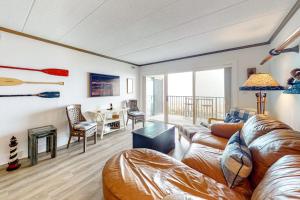 a living room with a couch and a table at Marigot Beach Condo in Ocean City