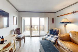 a living room with a couch and a table at Marigot Beach Condo in Ocean City