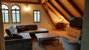 a living room with a couch and a table at Ferienwohnung Blauregen - NEU ab März 2026 in Hohnstein