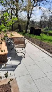 a group of picnic tables and benches on a sidewalk at Ferienwohnung Blauregen - NEU ab März 2026 in Hohnstein +10 photos