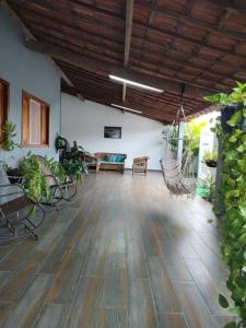a living room with a wooden floor and a hammock at casa de temporada em Piranhas ótimo lugar e conforto lila in Piranhas