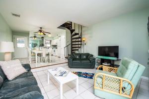 a living room with a couch and a table at Nassau Village 24 in Ocean City