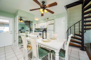 a kitchen and dining room with a white table and chairs at Nassau Village 24 in Ocean City
