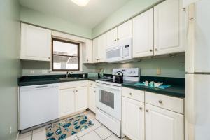 a kitchen with white cabinets and white appliances at Nassau Village 24 in Ocean City