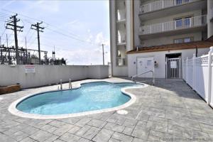 a swimming pool in front of a building at Cori Noel 102 in Ocean City