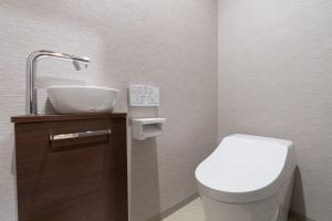 a small bathroom with a toilet and a sink at HOTEL PG3 - Vacation STAY 46492v in Habu