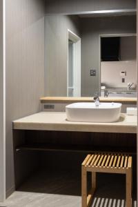 a bathroom with a sink and a mirror and a bench at HOTEL PG3 - Vacation STAY 46492v in Habu