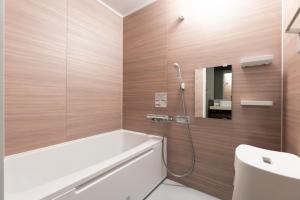 a bathroom with a bath tub and a sink at HOTEL PG3 - Vacation STAY 46492v in Habu