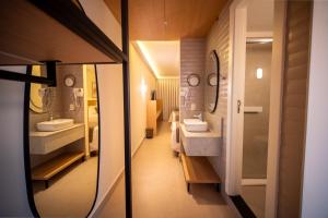 a bathroom with two sinks and two mirrors at Oklahoma Inn in Foz do Iguaçu