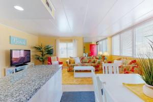 a living room with a couch and a tv at Oceanblock on One Twenty-Four in Ocean City +16 photos