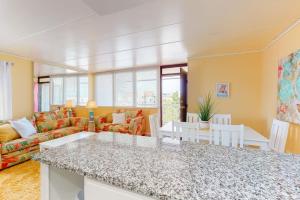a living room with a couch and a table at Oceanblock on One Twenty-Four in Ocean City