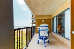 a blue chair sitting on a balcony with the ocean at Highpoint S 3G in Ocean City
