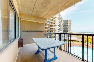 a blue bench on a balcony with a view of the ocean at Highpoint S 3G in Ocean City