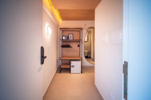 a hallway with white walls and a white refrigerator at Oklahoma Inn in Foz do Iguaçu