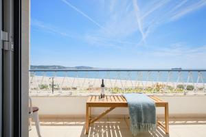 a table on a balcony with a view of the beach at Dreamy Sea View Balcony in Algés