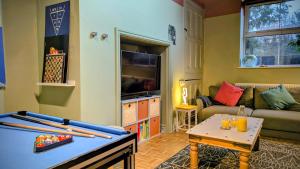 a living room with a pool table and a couch at Family Home in Tywyn - Game and Cinema Rooms in Tywyn +37 photos